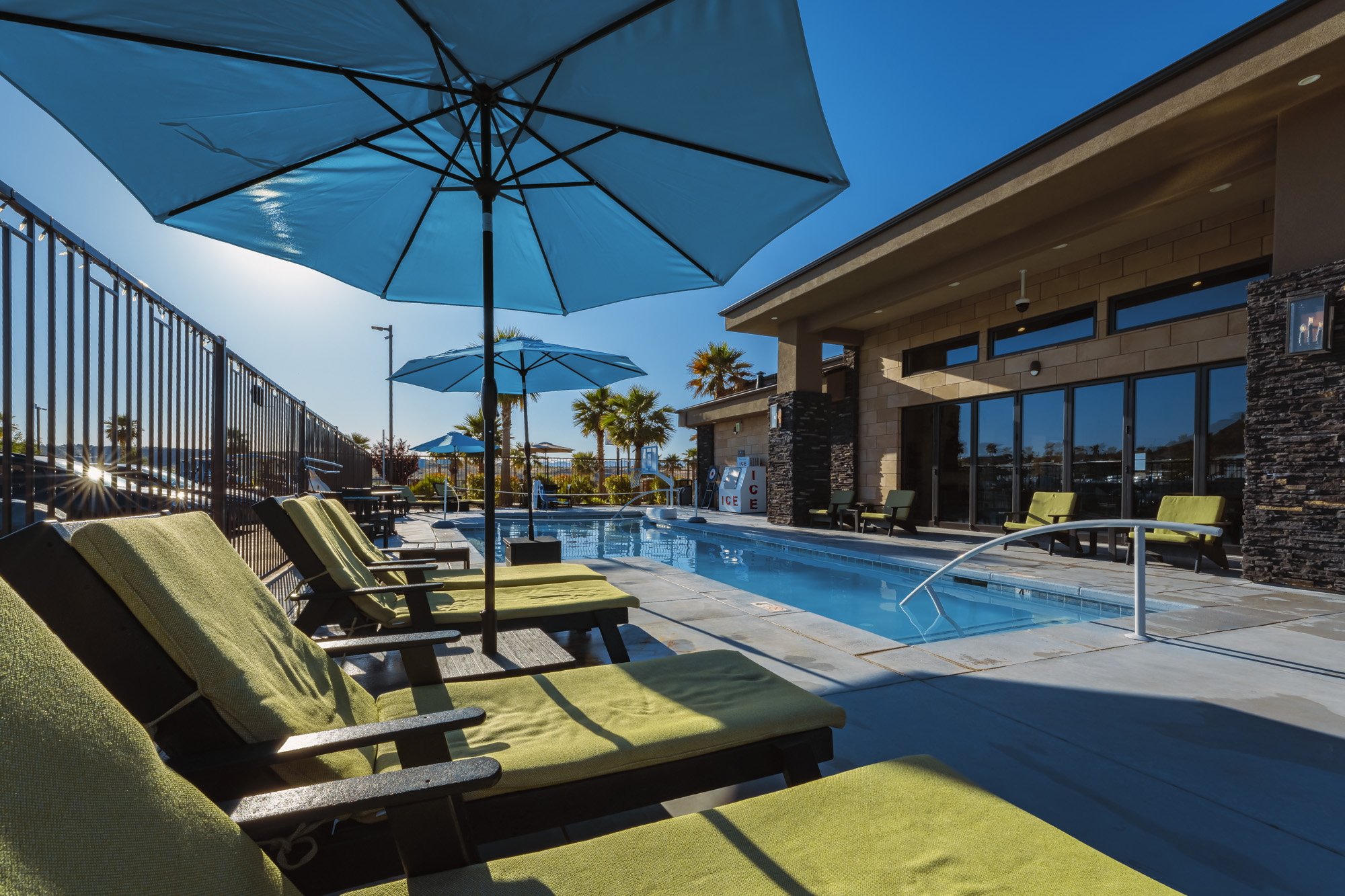 Luxury poolside lounge at Settlers Point RV Park in Utah with umbrellas and seating