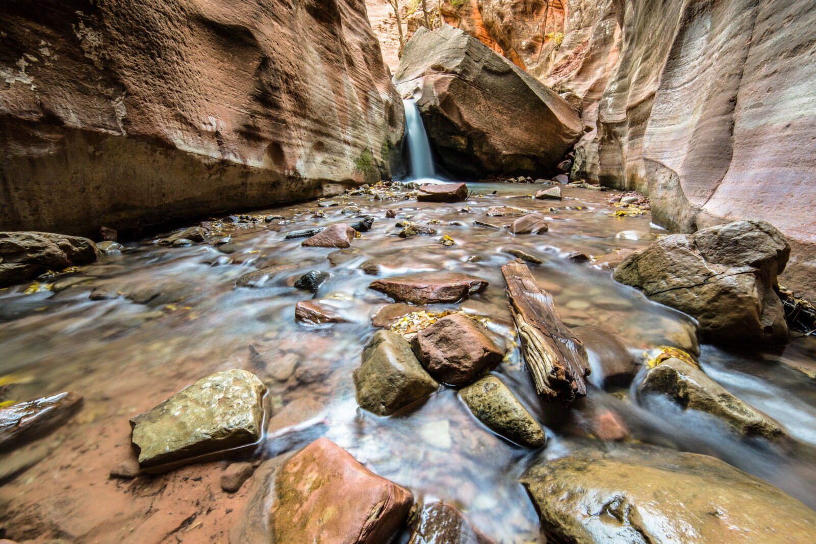 Majestic waterfall cascading over rocks in Kanarraville Canyon, Utah.